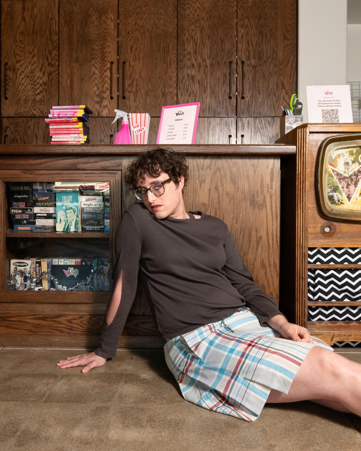 A director sits in front of a video counter.