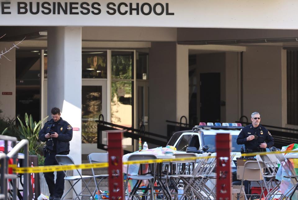 Police officers keep watch Thursday outside Frank and Estella Beam Hall the morning after a shooting left three dead at the University of Nevada, Las Vegas.