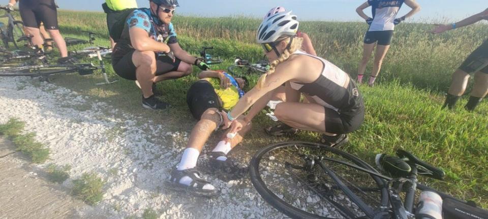 A rider on Day 3 of RAGBAI's 50th anniversry edition gets some first aid after a crash.