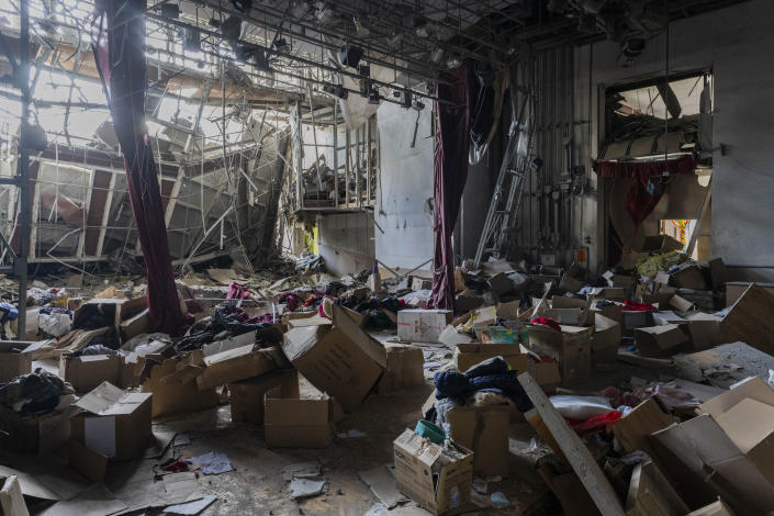 Boxes filled with clothing donations are scattered inside a destroyed cultural center in Derhachi, eastern Ukraine, Sunday, May 15, 2022. A Russian airstrike destroyed the venue on May 12. (AP Photo/Bernat Armangue)