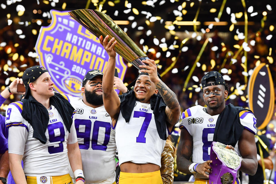 NEW ORLEANS, LOUISIANA - JANUARY 13: Grant Delpit #7 of the LSU Tigers raises the National Championship Trophy with Joe Burrow #9, left, Rashard Lawrence #90, and Patrick Queen #8 after the College Football Playoff National Championship game at the Mercedes Benz Superdome on January 13, 2020 in New Orleans, Louisiana. The LSU Tigers topped the Clemson Tigers, 42-25. (Photo by Alika Jenner/Getty Images)