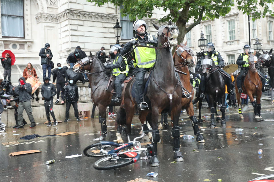 A bicycle is thrown at mounted police Police on horseback in Whitehall following a Black Lives Matter protest rally in Parliament Square, London, in memory of George Floyd who was killed on May 25 while in police custody in the US city of Minneapolis. PA Photo. Picture date: Saturday June 6, 2020. See PA story POLICE Floyd. Photo credit should read:  Yui Mok/PA Wire 