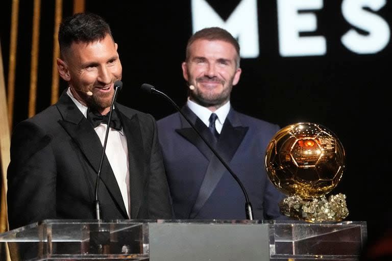 El co propietario del Inter Miami y ex estrella del fútbol mundial David Beckham, derecha, sonríe mientras Lionel Messi recibe el Balón de Oro 2023 (AP Foto/Michel Euler)