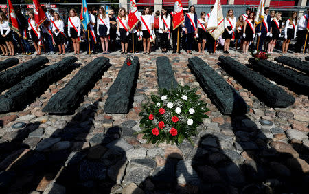 School delegations pay their respects to victims, during the ceremony commemorating the 79th anniversary of the Soviet Union's invasion of the eastern part of Poland during the outbreak of World War II, in front of the Monument to the Fallen and Murdered in the East, in Warsaw, Poland September 17, 2018. REUTERS/Kacper Pempel/Files