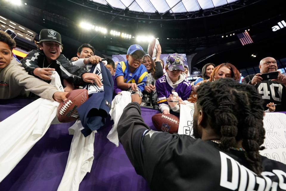 Dallas Cowboys cornerback Trevon Diggs signs autographs for fans after the 2023 Pro Bowl at Allegiant Stadium in Nevada. Diggs, a two-time Pro Bowler, is coming off an ACL injury that cut short his 2023 season. He hopes to return in time for the season opener.