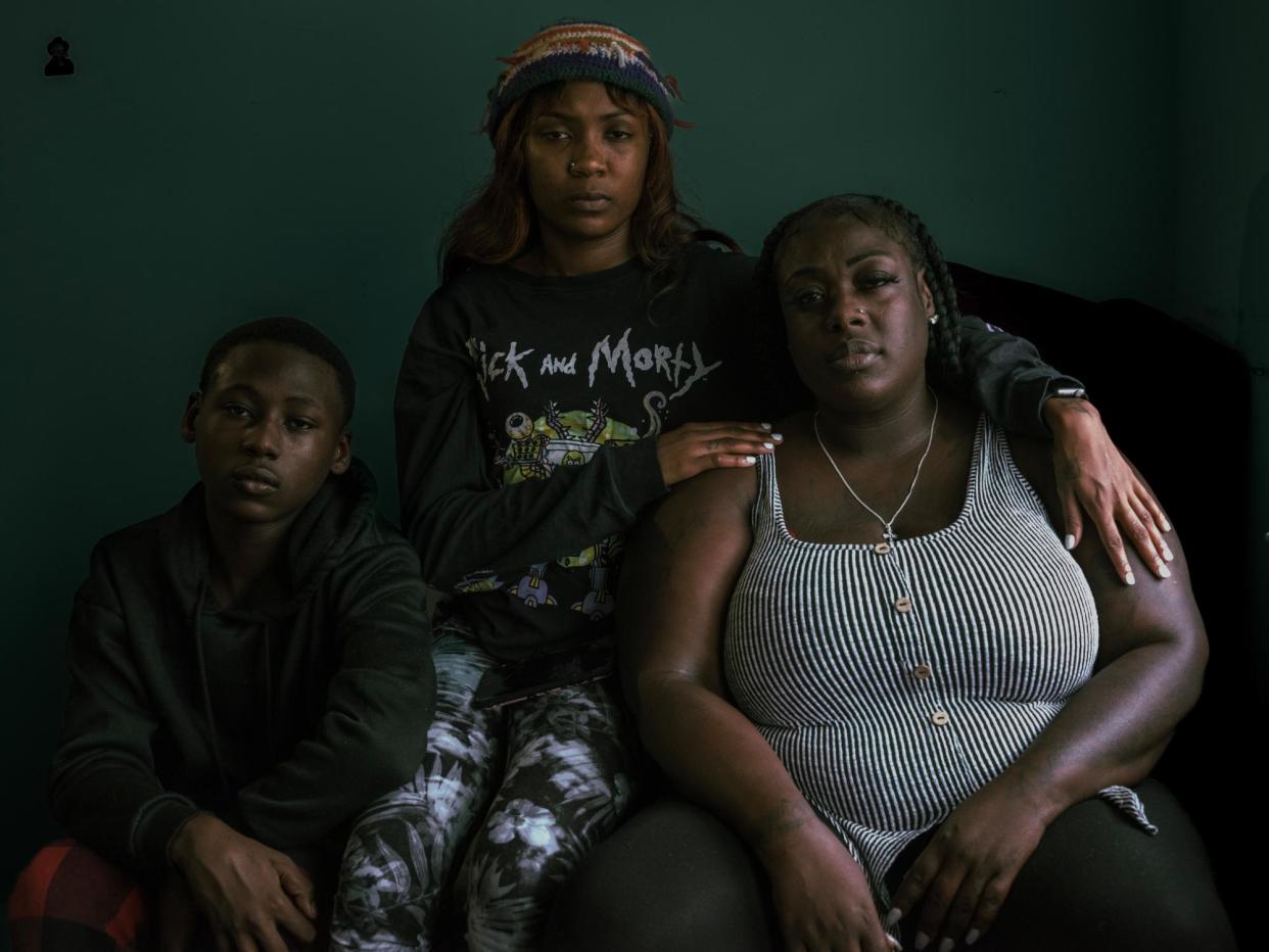 <span>Dysheeka Atkins, right, with her son Elijah Junior, 13, and stepdaughter Alexus, 25, in her apartment in New Jersey. Dysheeka’s partner, Elijah Sumler, died in prison two weeks before he was supposed to come home after serving 12 years.</span><span>Photograph: Ismail Ferdous/The Guardian</span>