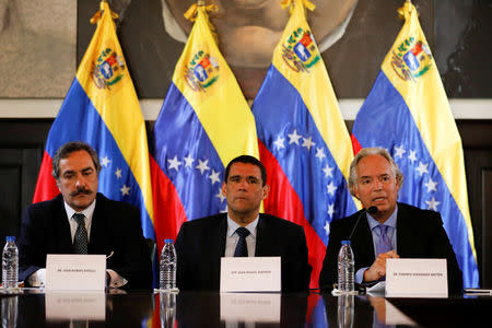 Juan Miguel Matheus (C), deputy of the opposition party Justice First (Primero Justicia), sits next to the lawyers Juan Manuel Rafalli (L) and Eugenio Hernandez-Breton during a news conference in Caracas, Venezuela April 2, 2017. REUTERS/Carlos Garcia Rawlins