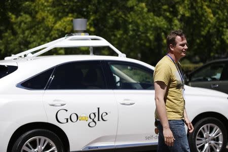 Chris Urmson, director of Google's Self-Driving Car Project, stands in front of a self-driving car at the Computer History Museum after a presentation in Mountain View, California in this May 13, 2014 file photo. REUTERS/Stephen Lam