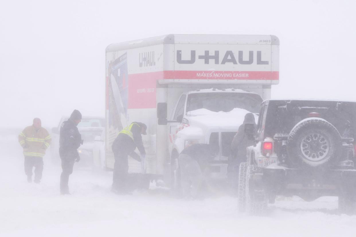 Police and emergency workers try to free a U-Hall moving truck from the snow on Mountain View Parkway in Lehi, Utah, on February 22,  2023 (AFP via Getty Images)
