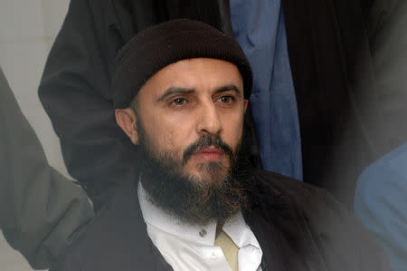 FILE PHOTO: Yemeni convict Jamal al-Badawi listens to the verdict being announced from behind the bars in a Sanaa appeals court, February 26, 2005. REUTERS/Khaled Abdullah/File Photo