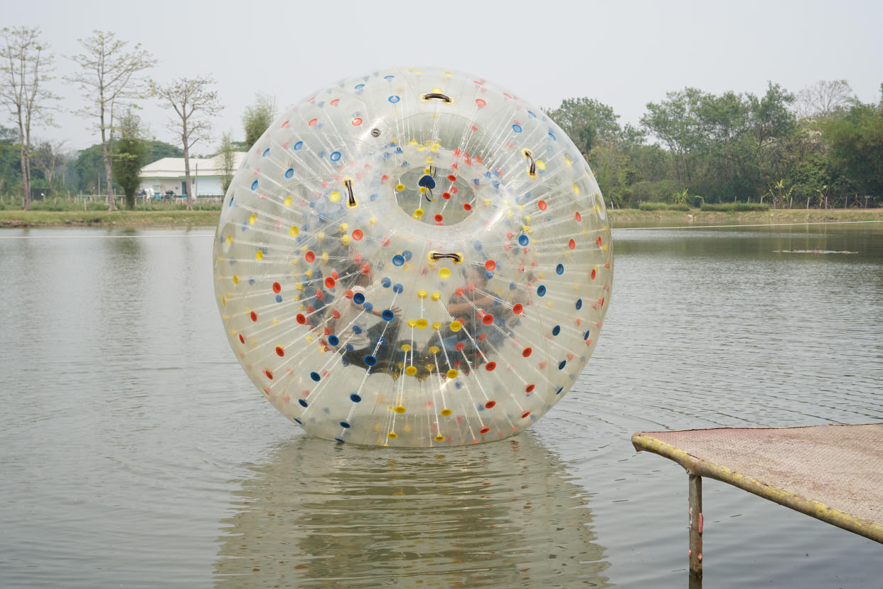 Chiang Mai, Thailand - March 26 2016: People play zorb inflatable ball on the pond at X centre which is the one-stop for all adrenaline junkies with a wide range of thrilling activites in Chiang Mai, Thailand on March 26, 2016.