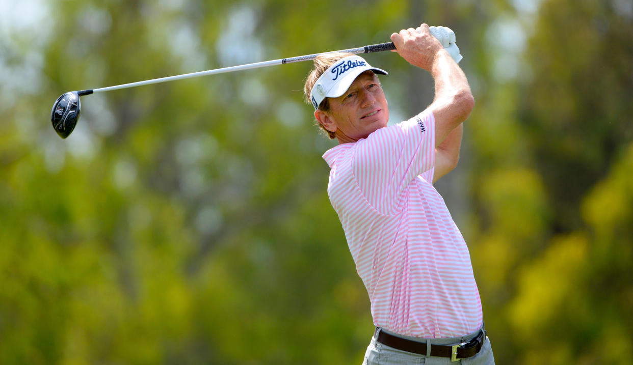  Faxon strikes his tee shot and watches his drive 