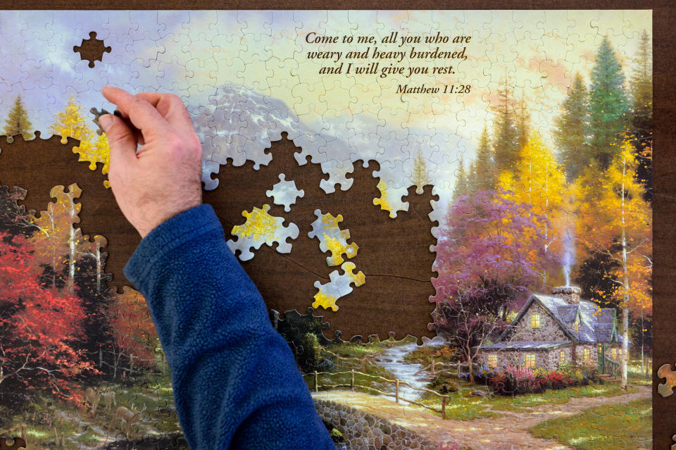 Chris puts together a puzzle at a warming station that opened in a former Chase bank on Jan. 15. The new location, opened by Catholic Charities, is large enough to allow for social distancing.<span class="copyright">Rebecca Kiger</span>