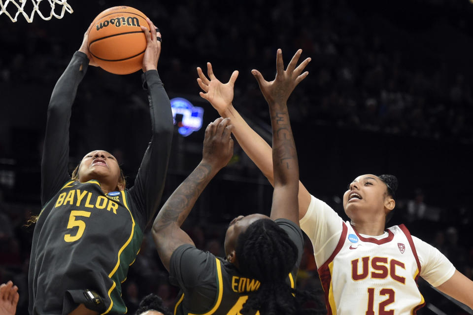 Baylor guard Darianna Littlepage-Buggs (5), Baylor forward Dre'Una Edwards, center, and Southern California guard JuJu Watkins (12) go for a rebound during the first half of a Sweet 16 college basketball game in the NCAA Tournament, Saturday, March 30, 2024, in Portland, Ore. (AP Photo/Steve Dykes)