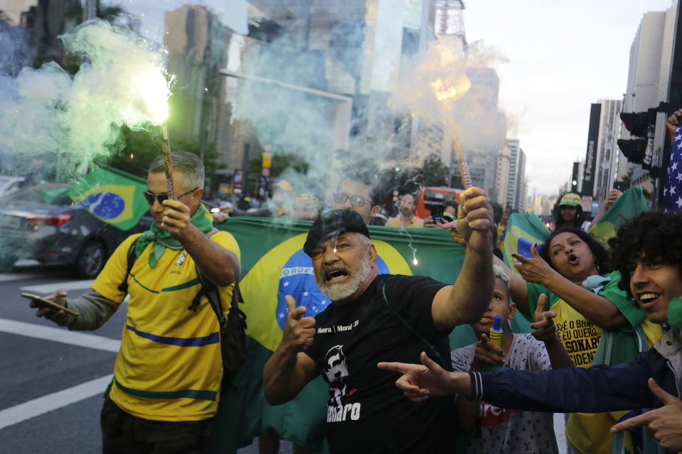 Supporters of Brazilian presidential candidate Jair Bolsonaro cheer as they gather on Paulista Ave. to wait for election runoff results, in Sao Paulo, Brazil, Sunday, Oct. 28, 2018. Brazilian voters decide who will next lead the world's fifth-largest country, the left-leaning Fernando Haddad of the Workers' Party, or far-right rival Bolsonaro of the Social Liberal Party. (AP Photo/Nelson Antoine)