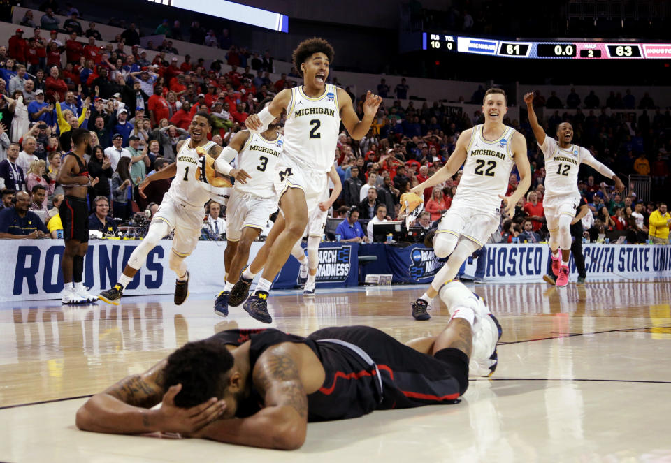 Michigan’s Jordan Poole (2) celebrates with teammates after his game-winning shot to oust Houston from the 2018 NCAA tournament. (Getty)