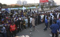 Pakistani cricket fans stand in a queue to enter National Stadium to watch the Pakistan Super League match in Karachi, Pakistan, Thursday, Feb. 20, 2020. (AP Photo/Fareed Khan)
