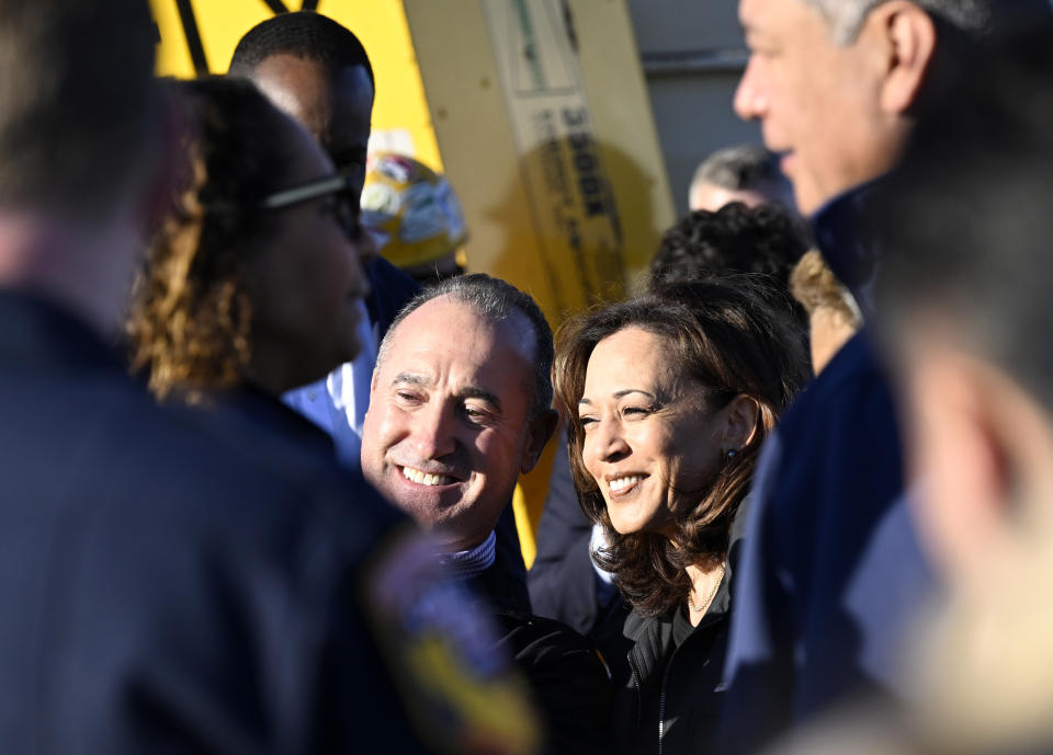 Vice President Kamala Harris, center right, poses for a selfie with a worker of the I-10 freeway, which was closed by an underpass fire on Saturday, Nov. 11, 2023, in Los Angeles, Sunday, Nov. 19. (AP Photo/Alex Gallardo)