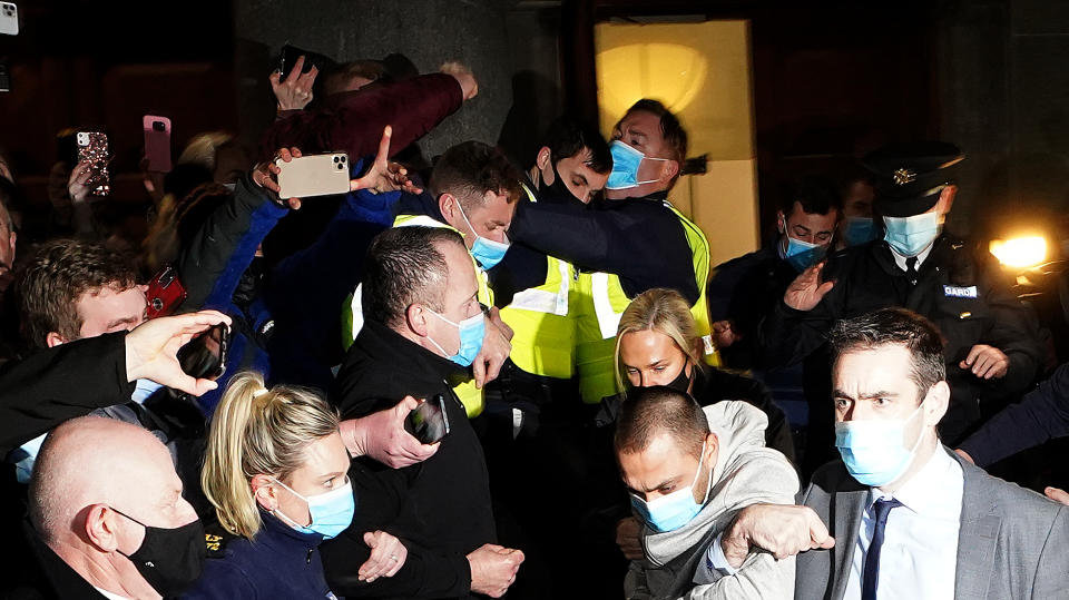 Jozef Puska, 31, (bottom second right grey top) is led to a police van after appearing at Tullamore District Court where he is charged with the murder of Irish teacher Ashling Murphy. Source: Brian Lawless/PA Wire