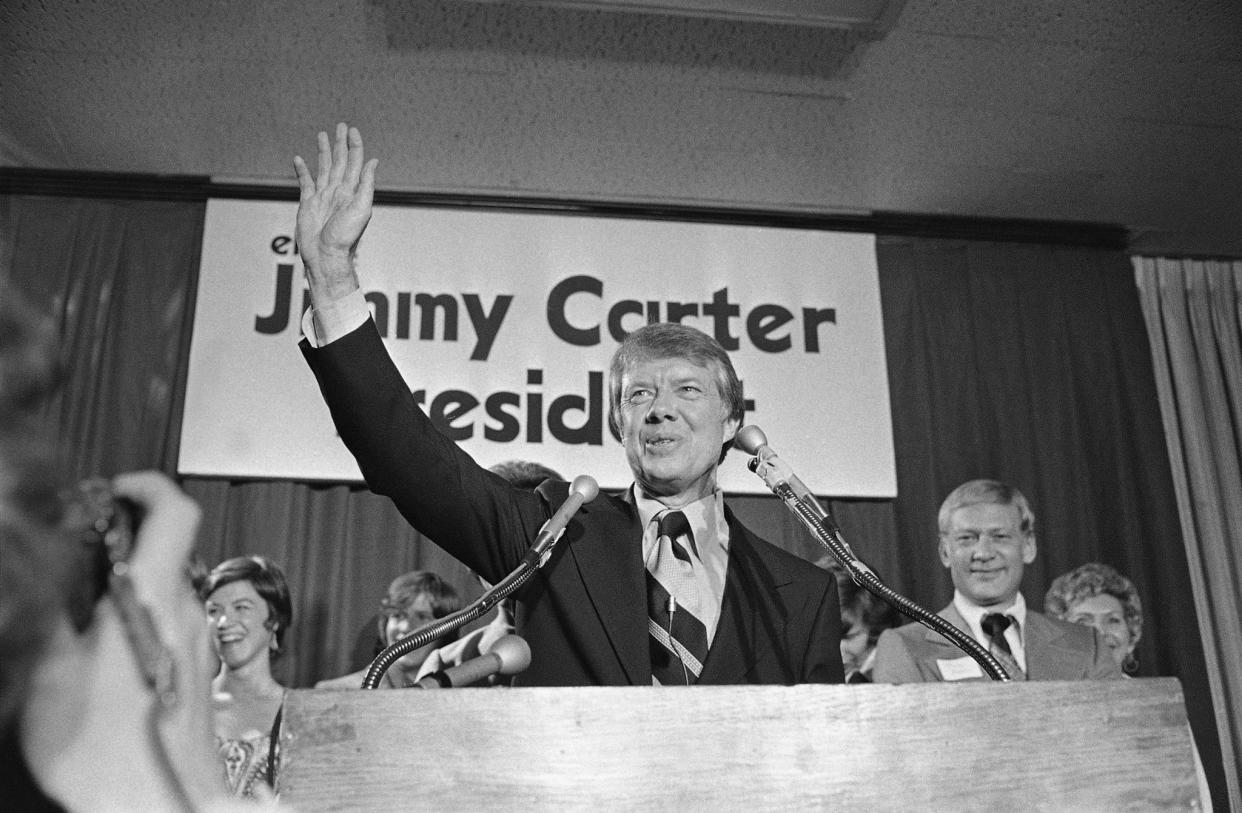 Gov. Jimmy Carter waves to a crowd on Dec. 12, 1974, gathered in Atlanta, where he officially announced his Democratic candidacy for the presidency. Carter promised to “restore integrity, confidence and businesslike management to the federal government.”