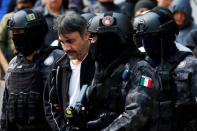 Accused drug kingpin Damaso Lopez (C), nicknamed “The Graduate”, is escorted by police officers after he was arrested, in Mexico City, Mexico May 2, 2017. REUTERS/Carlos Jasso