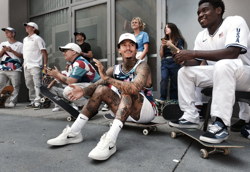 Image: Nyjah Huston, center, laughs with teammate Zion Wright, right, before they are introduced with the rest of the first U.S. Olympic skateboarding team (Richard Vogel / AP)