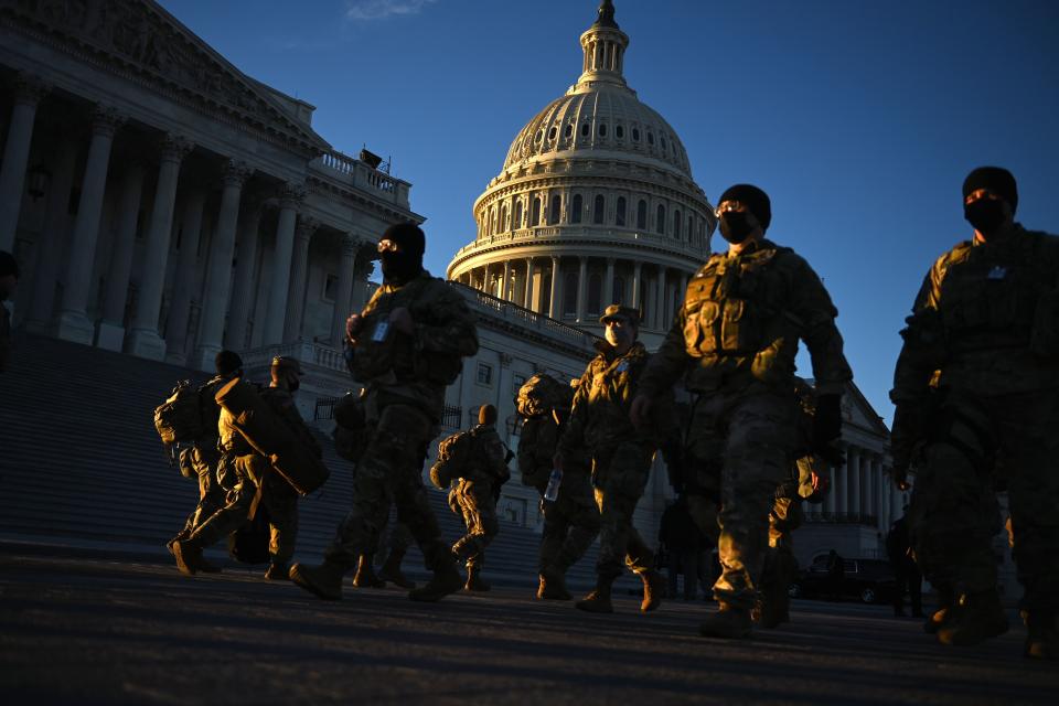 Members of the US National Guard are seen outside the US Capitol on January 19, 2021 in Washington, DC, ahead of the 59th inaugural ceremony for President-elect Joe Biden and Vice President-elect Kamala Harris. (Photo by Brendan SMIALOWSKI / AFP) (Photo by BRENDAN SMIALOWSKI/AFP via Getty Images)