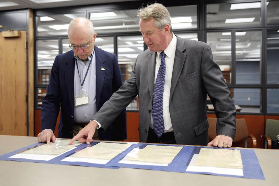 Jim Folts, left, head of researcher services at the state archives, and State Archivist Thomas Ruller, view 1828 court documents related to Sojourner Truth, at the New York State Archives in Albany on June 9. In January, Folts found the court records detailing Sojourner Truth's fight to be reunited with her young son, who had been sold into slavery in Alabama. The papers will be on display Wednesday in Kingston.