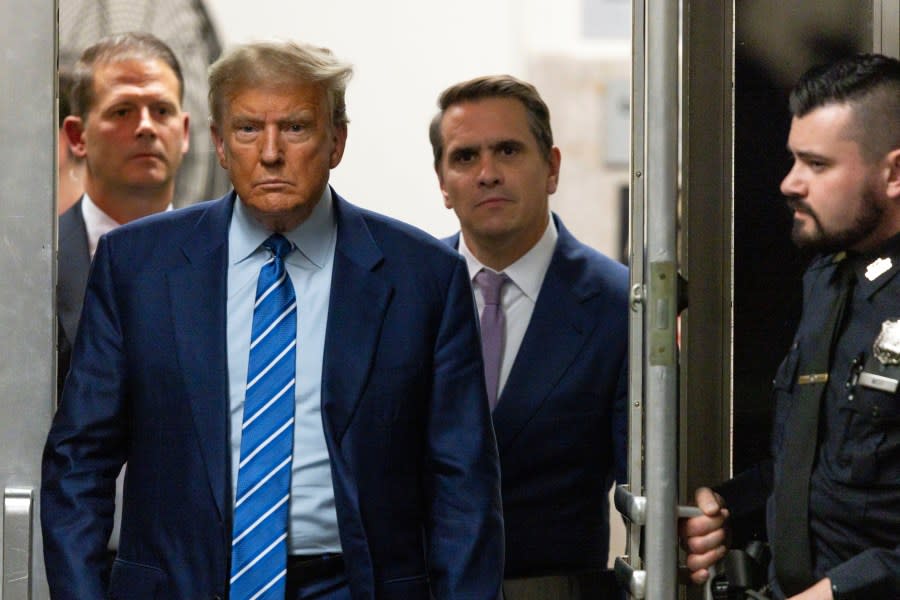 Former President Donald Trump walks through a doorway during the second day of jury selection, Tuesday, April 16, 2024, at Manhattan criminal court in New York. Trump is charged with falsifying business records to cover up a sex scandal during his 2016 campaign. (Justin Lane/Pool Photo via AP)