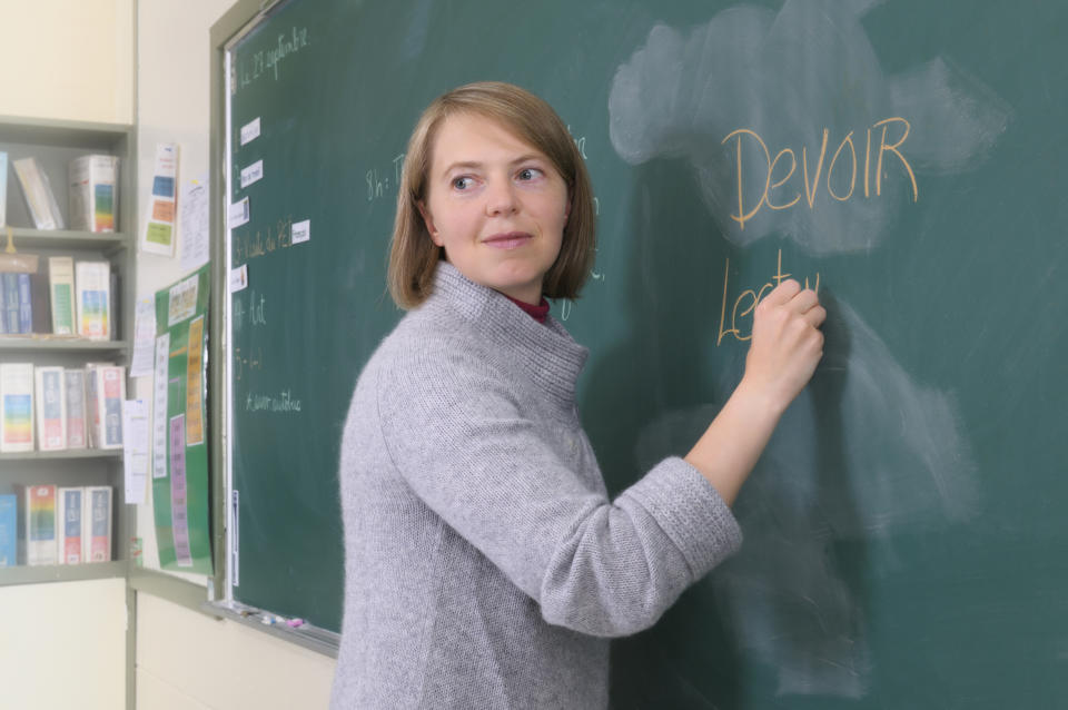 a french teacher writing on the board