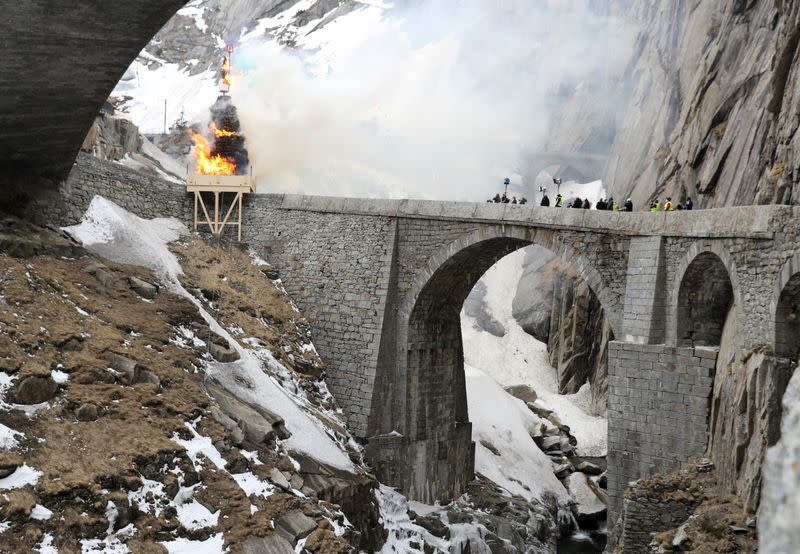 The Boeoegg, a snowman, is burning in a bonfire on Devil's Bridge near Andermatt