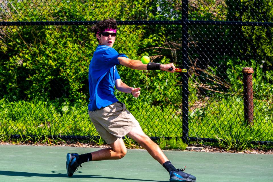 Fairhaven's Kole Pinto slides across the court for the backhanded shot.