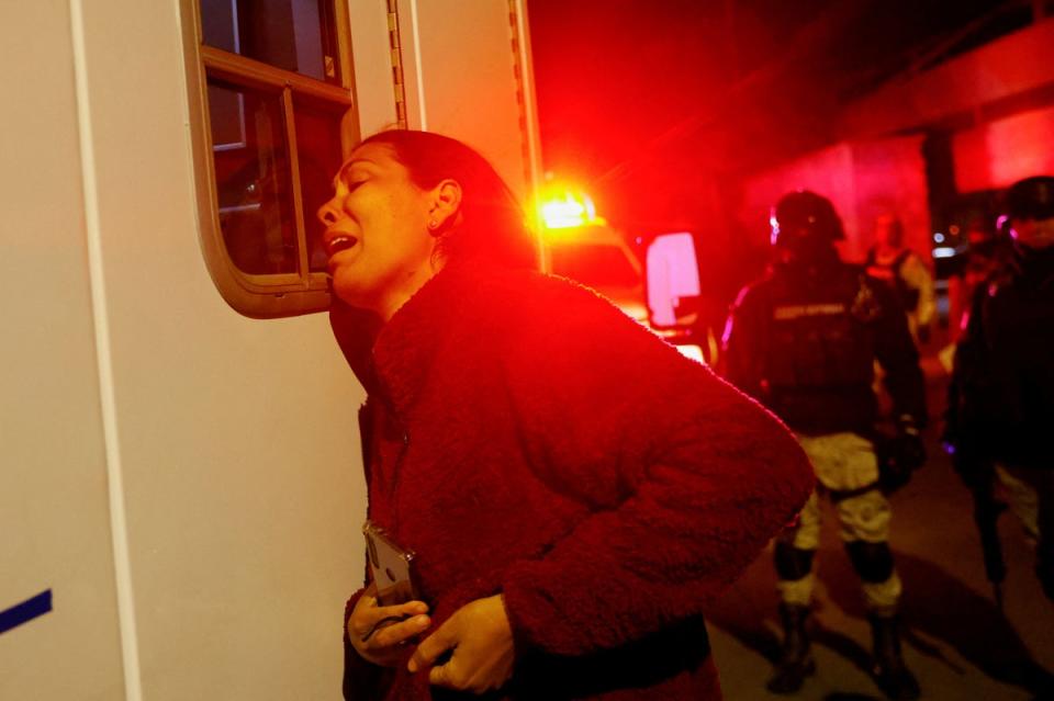 Viangly, a Venezuelan migrant, reacts outside an ambulance for her injured husband (REUTERS)