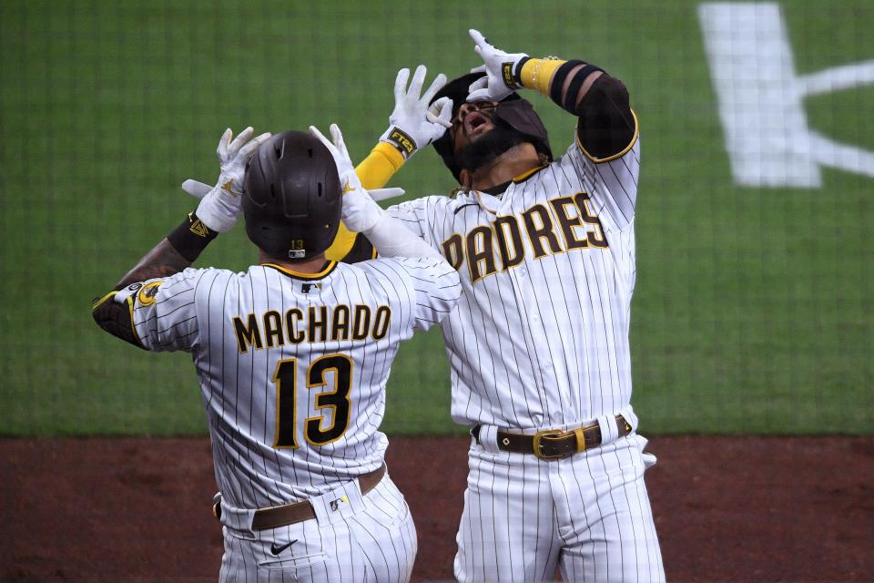 Manny Machado and Fernando Tatis Jr. celebrate Tatis' home run against the Dodgers on Friday.