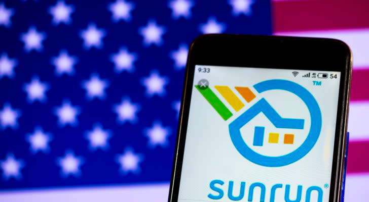 The Sunrun (RUN) logo is displayed on a smartphone screen in front of an American flag.