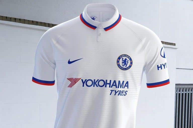 Chelsea stars N'Golo Kante, Cesar Azpilicueta, Ethan Ampadu and Fran Kirby have launched the club's new away strip for the 2019-20 campaign.The white shirt is inspired by the 1960s Mod culture which thrived in the club's area of west London.A fresh white polo with button-down collar, the Nike strip includes a red and blue trim around the collar and sleeves.The buttons are inscribed with the message “Pride of London” and the complete kit includes white shorts and royal blue socks. “The kit is really beautiful, with so many nice touches," said forward Fran Kirby. "I know a little bit about Mod fashion and culture and you can see its influence on the kit. I think it’s a shirt you could wear to the game, but also in any situation, and I’m sure the fans will like it." The kit will be debuted during pre-season and is available to purchase at nike.com.