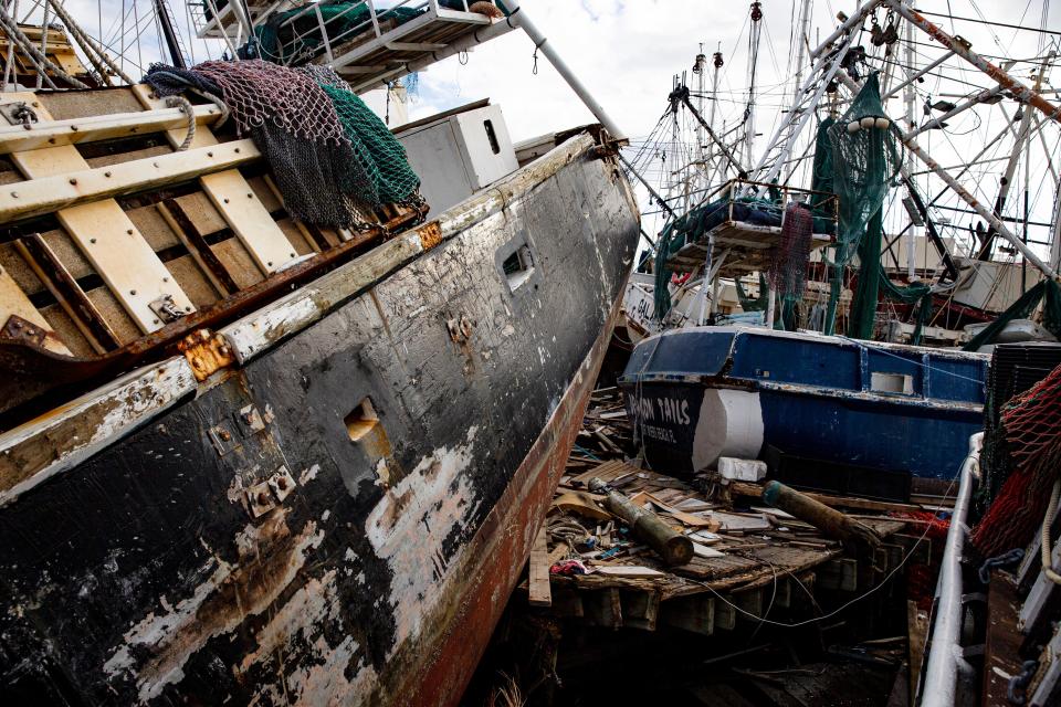 Damaged shrimp boats on Fort Myers Beach on Oct. 20, 2022. The shrimping industry was severely impacted by Hurricane Ian. Most of the fleet was washed onto land by the storm surge.