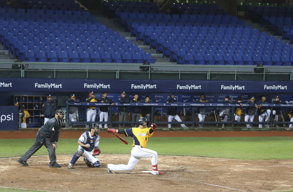 Players of Chinese Professional Baseball League play baseball with no audience at Xinzhuang Baseball Stadium in New Taipei City, Taiwan, Friday, April 24, 2020. Taiwan's five-team Chinese Professional Baseball League is barring spectators over concerns they would spread the deadly coronavirus, meaning games are played with plastic seats void of fans.(AP Photo/Chiang Ying-ying)