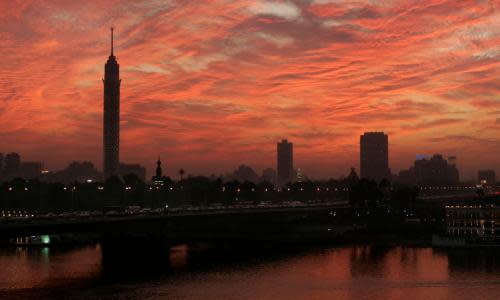 The sky over the Nile behind the Cairo Tower, left, is lit up red at sunset in Cairo, Egypt, Wednesday, Nov. 19, 2008. (AP Photo/Ben Curtis)