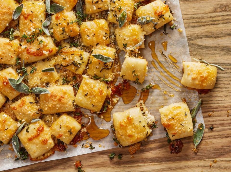 parmesan bread bites topped with honey drizzle