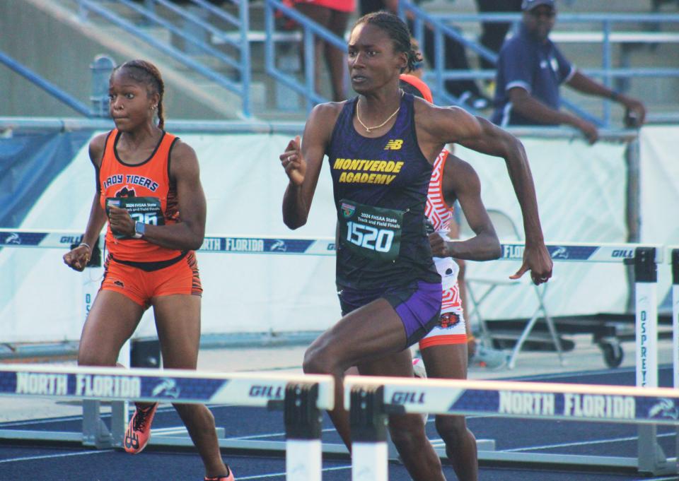 Michelle Smith (1520) of Montverde Academy leads Alayezia Williams (1236) of Cocoa on her way to victory in the girls 100-meter hurdles.