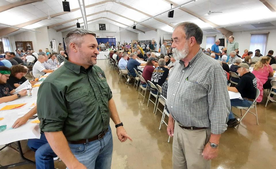 Jeremy Banfield, left, elk biologist for the Pennsylvania Game Commission, left, talks with Richard Berkley, president of the Somerset County Sportsmen's League, on Sept. 20 in Berlin, Pa. Banfield spoke to the group about the wild elk herd in northcentral Pennsylvania.