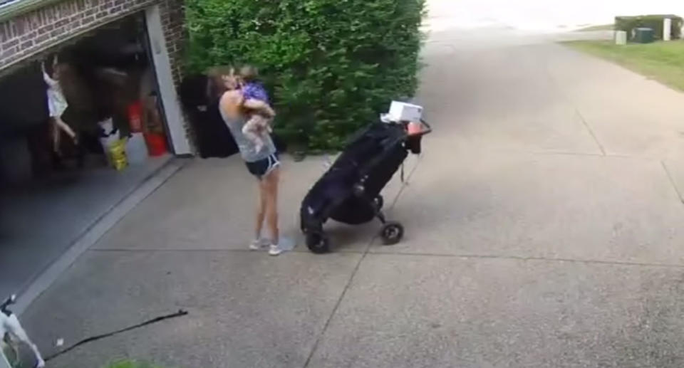 The mum removes the baby from the pram while her little girl hangs nearly two metres from the ground. Source: YouTube/ Erica Dilley