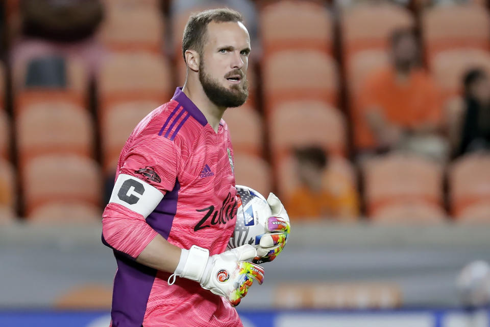 FILE- Seattle Sounders goalkeeper Stefan Frei carries the ball during the first half of an MLS soccer match against the Houston Dynamo on Oct. 16, 2021, in Houston. Frei expressed his support to women's right to an abortion in a Tweet. “Impose a constitutional right to concealed carry of firearms, and following day end the fundamental constitutional protection of reproductive rights!? Our country is actively moving in the wrong direction," Frei said, referencing the Supreme Court's decision the day before that gave expanded gun rights. (AP Photo/Michael Wyke)