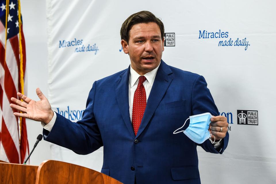 Florida Gov. Ron DeSantis speaks holding his facemask during a press conference to address the rise of coronavirus cases in the state, at Jackson Memorial Hospital in Miami, on July 13, 2020. - Virus epicenter Florida saw 12,624 new cases on July 12 -- the second highest daily count recorded by any state, after its own record of 15,300 new COVID-19 cases a day earlier. (Photo by CHANDAN KHANNA / AFP) (Photo by CHANDAN KHANNA/AFP via Getty Images)