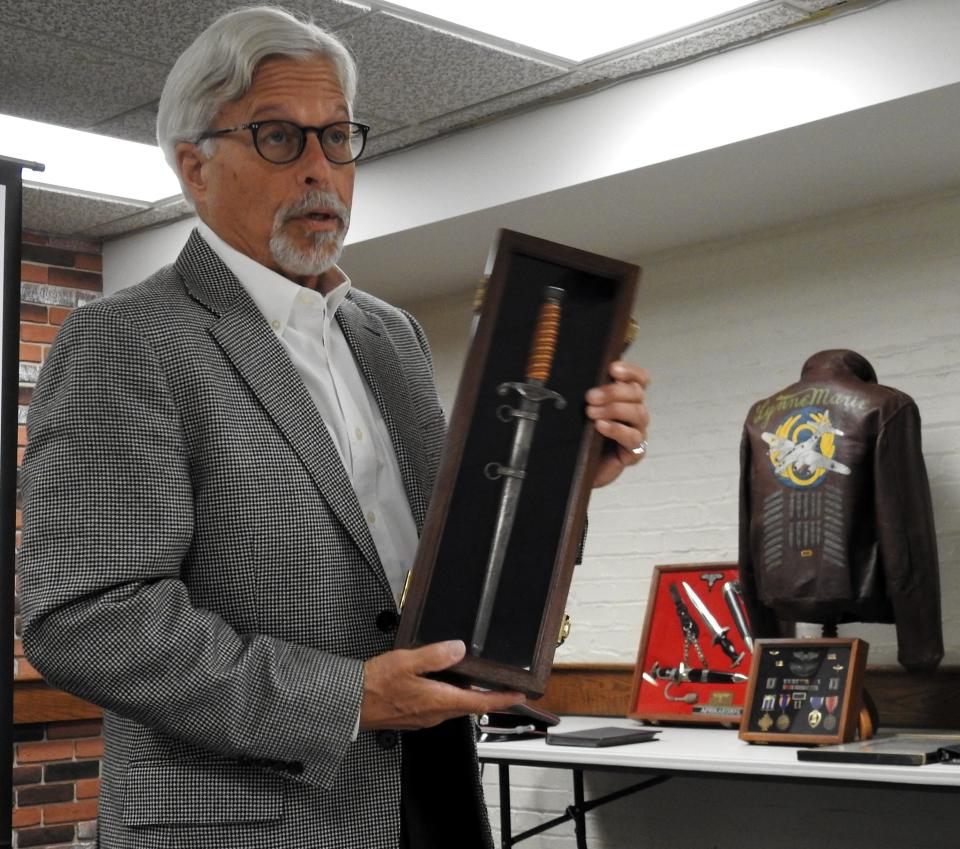 Bill Given displays one of the many Nazi daggers part of his collection of more than 1,000 military items. He said U.S. soldiers brought a lot of Nazi items back from Europe as trophies. Given gave a talk last fall at the Coshocton County District Library.