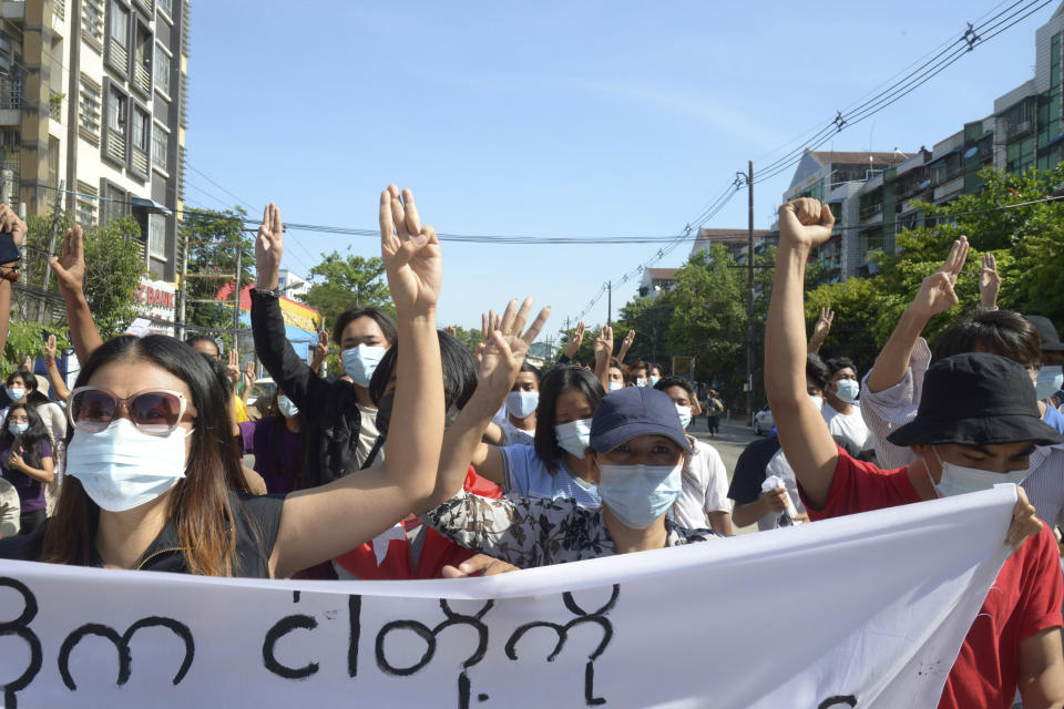 Anti-coup protesters flash the three-finger salute during a demonstration in Yangon, Myanmar, Friday, May 14, 2021. (AP Photo)