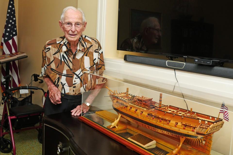 Jack Wagner poses next to a model he made of the USS Confederacy, a Revolutionary War era Frigate. The model is on display in the game room at The Sheridan at Lakewood Ranch.