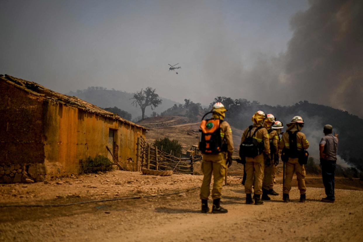 Personnel of the Protection and Relief Intervention Group (GIPS) specialised in combating forest fires, arrive to battle a wildfire in Reguengo, Portalegre district, south of Portugal (AFP via Getty Images)