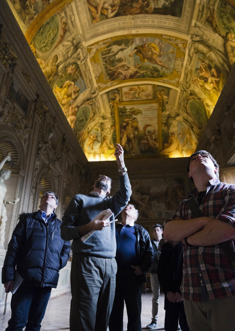 A guide, second from left, shows the frescoed ceilings of the Carracci Gallery in the Farnese Palace that hosts the French Embassy in Rome, Wednesday, Feb. 26, 2014. The World Monuments Fund Europe will allocate some 800 million Euros for the restoration of the about 140 square meters of 16th century frescoes by Annibale and Agostino Carracci that will begin mid March and are expected to be completed in 2015. (AP Photo/Domenico Stinellis)